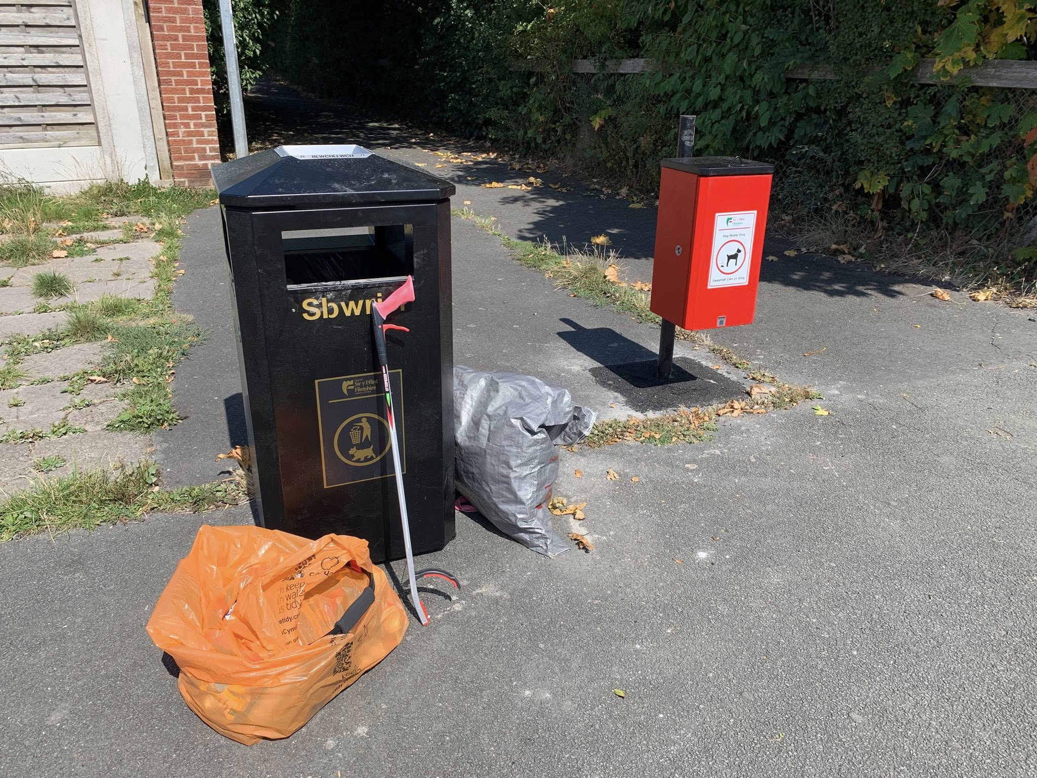 New red dog waste bin on Ffordd Newydd